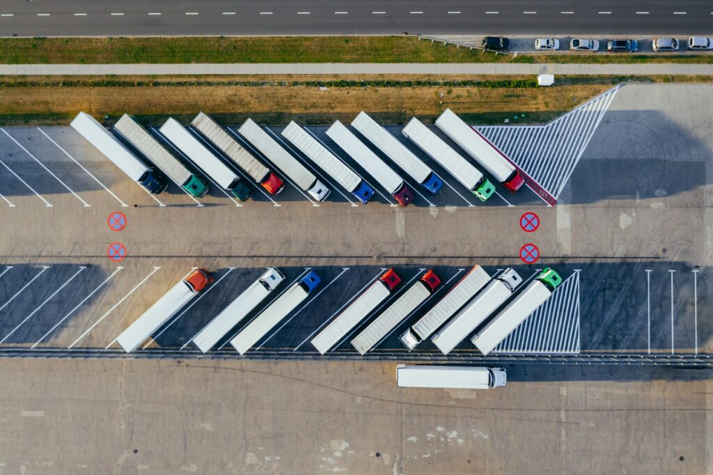 Fleet of parked commercial trucks at a logistics yard