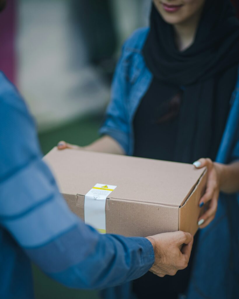 Courier handing a package for pickup and delivery