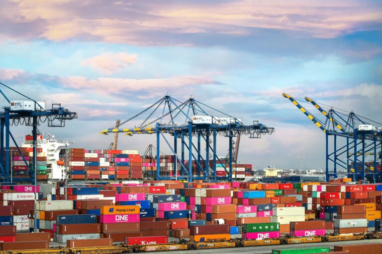 Red and blue cargo containers at a port