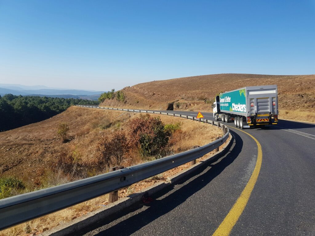White and blue freight truck on the road